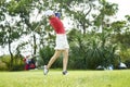 Asian woman playing golf swinging golf club for teeing off in course Royalty Free Stock Photo