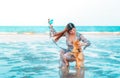 Woman is playing with her pet dog on a summer beach, for Animal loving and relaxing cocnept