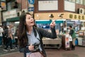 Asian woman pointing at somewhere.