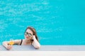 Asian woman in pool with glass of orange juice Royalty Free Stock Photo