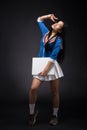 Asian woman posing with blank poster in studio