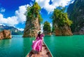 Asian woman posing on boat in Ratchaprapha dam Khao sok national park at suratthani,Thailand Royalty Free Stock Photo