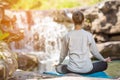 Asian woman practices yoga