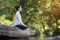 Asian woman practices yoga