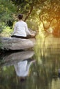 Asian woman practices yoga