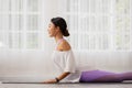 Asian woman practising yoga, Cobra exercise, Bhujangasana stance, working out, and wearing sportswear