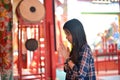 Asian woman prays respect to Chinese buddha in Chinese temple