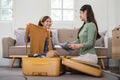 Asian woman prepare to pack clothes travel places with her friends. Asian beautiful two women friend pack things in your Royalty Free Stock Photo