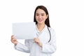 Asian woman professional doctor who wears medical coat standing confidently smiling and holds shows white paper to present Royalty Free Stock Photo