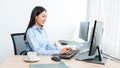 Asian woman Programming working with computer and typing data code to developing program at table In Office, technology concept Royalty Free Stock Photo