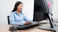 Asian woman Programming working with computer and typing data code to developing program at table In Office, technology concept Royalty Free Stock Photo