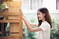 Asian woman put sticky memo paper note on parcel mail box and ready to send to customer. Business owner and Online shopping