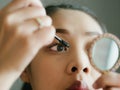 Woman is putting make up mascara on her eyelashes. Royalty Free Stock Photo