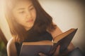 Asian woman reading a book vintage style. Royalty Free Stock Photo