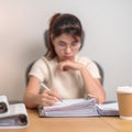 Asian woman reading financial report, female businesswoman sign contract or writing documents paper at home or office late night