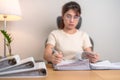 Asian woman reading financial report, female businesswoman sign contract or writing documents paper at home or office late night