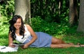 Asian woman reading a magazine in park Royalty Free Stock Photo