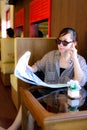 Asian woman reading newspaper