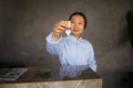 Asian woman receptionist handing over the keys to the room above the counter Royalty Free Stock Photo