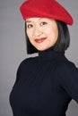 Asian Woman with a Red Beret Royalty Free Stock Photo