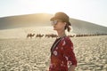 Asian woman in red dress looking at view in desert