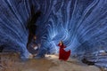 Asian woman in a red dress visits a blue cave in Tak Province, Thailand