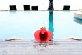 Asian woman with red hat relax on swimming pool Royalty Free Stock Photo