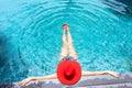 Asian woman with red hat relax on swimming pool Royalty Free Stock Photo