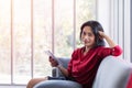 Asian woman in red shirt using tablet computer Royalty Free Stock Photo