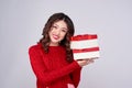 Asian woman in red warm clothes with gifts. Holidays New Year and Christmas