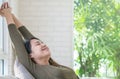 Asian woman relax on sofa in her free time in room background