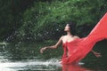 Asian woman relaxing and enjoying playing with water and splash at tropical exotic river with turquoise amazing color water in bea