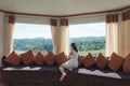 Asian woman relaxing and enjoying the tropical forest view on sofa at panorama room in bright day Royalty Free Stock Photo