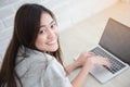 Asian woman is relaxing and smiling using a laptop,Lifestyle and education concept