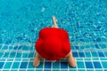 Asian woman relaxing in swimming pool