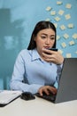 Asian woman reviewing bank statement holding credit card