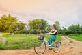 Asian woman riding a bicycle at countryside