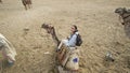 Asian woman riding camel  at Giza pyramid Egypt scary activity and exciting for tourist Royalty Free Stock Photo