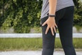 Asian woman runner suffering from pain in legs be injured,Hand touching her muscle thigh after jogging on track running Royalty Free Stock Photo