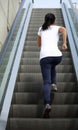 Asian woman running on escalator stairs Royalty Free Stock Photo