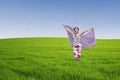 Asian woman running on green field Royalty Free Stock Photo