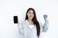 The Asian woman`s hand is holding a credit card and using a smartphone for online shopping and internet payment in a happy way Royalty Free Stock Photo