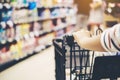 Asian woman`s hand with supermarket, trolley and many objects th Royalty Free Stock Photo