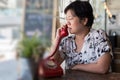 Asian women dismal phone call in a coffee shop