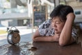 Asian women sleep in coffee shop cafe with clock Royalty Free Stock Photo