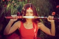 Asian woman with samurai sword on the nature Royalty Free Stock Photo