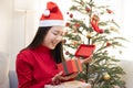 Asian Woman With Santa Claus  Open Her Christmas Present Box near the Christmas Tree Royalty Free Stock Photo