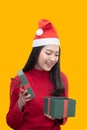Asian Woman With Santa Claus  Open Her Christmas Present Box near the Christmas Tree Royalty Free Stock Photo