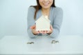 Asia woman saving money with shaped house box Royalty Free Stock Photo