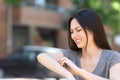 Asian woman scratching itchy arm in the street Royalty Free Stock Photo